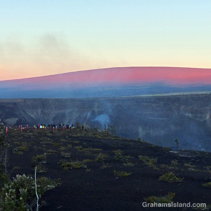 People view the lava cone and lake at Kilauea Volcano in late 2021