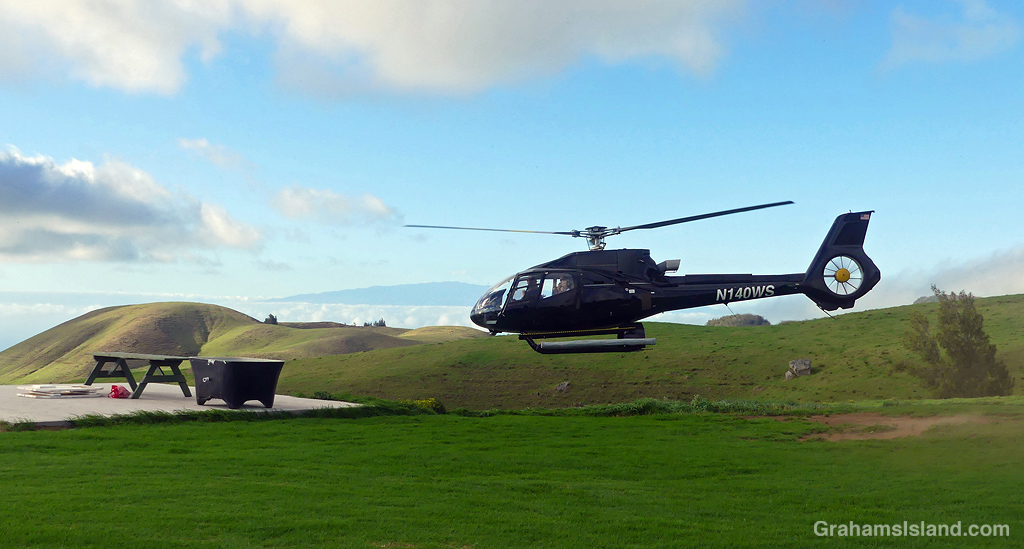 A Helicopter taking off from a ranch on Kohala Mountain, Hawaii